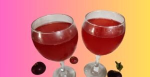 2 chilled glasses of deep purple Kokum Sherbat, served with ice cubes and garnished with a slice of kokum, exuding a tangy and refreshing appearance.