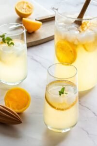 Serving honey ginger lemonade in a chilled glass with lemon slices