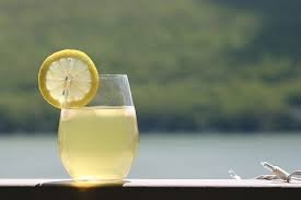 A refreshing Indian summer drinks, Nimbu Pani (lemonade), served in a glass with a lemon slice garnish, perfect for cooling down on hot days.